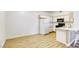 Bright kitchen features wood-style flooring, white appliances, and ample cabinet space at 5751 E Hacienda Ave # 243, Las Vegas, NV 89122