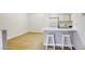 Bright kitchen area with wood-style flooring, white cabinets, and a convenient breakfast bar at 5751 E Hacienda Ave # 243, Las Vegas, NV 89122