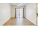 Bright, airy room featuring wood laminate flooring, white trim, and large window at 5751 E Hacienda Ave # 243, Las Vegas, NV 89122