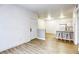 Open-concept living room with new flooring that flows into the kitchen area at 5751 E Hacienda Ave # 243, Las Vegas, NV 89122