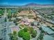 Extensive aerial view of the community, surrounding golf course, and distant mountains at 6076 Wheat Penny Ave, Las Vegas, NV 89122