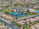 Residential aerial view highlighting community tennis courts, clubhouse, pool, and tree-lined streets and houses at 6076 Wheat Penny Ave, Las Vegas, NV 89122