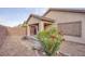 Cozy back yard featuring decorative desert landscaping and a covered patio with brick pavers at 6076 Wheat Penny Ave, Las Vegas, NV 89122