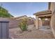 Backyard featuring a covered patio, gravel and brick landscaping, and a privacy wall at 6076 Wheat Penny Ave, Las Vegas, NV 89122