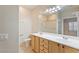 Bright bathroom featuring a double vanity, an oversized mirror, and a shower with sliding glass doors at 6076 Wheat Penny Ave, Las Vegas, NV 89122