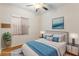 Cozy bedroom with a comfortable bed, stylish décor, hardwood floors, natural light, and neutral paint at 6076 Wheat Penny Ave, Las Vegas, NV 89122