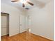 Spacious bedroom with light-colored walls and wood-look floors features a closet and an entry door at 6076 Wheat Penny Ave, Las Vegas, NV 89122