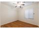 Cozy bedroom with hardwood floors, ceiling fan, and a large window for plenty of light at 6076 Wheat Penny Ave, Las Vegas, NV 89122