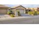Exterior shot of the home showcasing the driveway, garage, and landscaping at 6076 Wheat Penny Ave, Las Vegas, NV 89122
