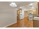 Functional kitchen layout includes white appliances, wood cabinets, and hardwood flooring at 6076 Wheat Penny Ave, Las Vegas, NV 89122