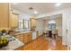 Well-lit kitchen with light wood cabinets, laminate countertops, and an adjacent dining area for casual meals at 6076 Wheat Penny Ave, Las Vegas, NV 89122