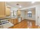 Efficient kitchen design with wood cabinets, granite countertops, and hardwood floors throughout at 6076 Wheat Penny Ave, Las Vegas, NV 89122