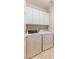 Laundry room with white washer and dryer and white overhead cabinets for storage at 6076 Wheat Penny Ave, Las Vegas, NV 89122