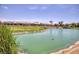 Scenic waterfront view of community pond surrounded by lush landscaping at 6076 Wheat Penny Ave, Las Vegas, NV 89122
