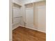 Walk-in closet featuring wood-look floors and built-in shelving and hanging rods at 6076 Wheat Penny Ave, Las Vegas, NV 89122