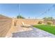 Private backyard showcasing a desert landscape with a chaise lounge and string lights at 6276 Desert Orchid Way, Las Vegas, NV 89141