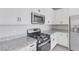 Bright modern kitchen with stainless steel appliances and white cabinetry at 6276 Desert Orchid Way, Las Vegas, NV 89141