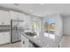Bright kitchen with granite countertops, stainless steel appliances, and a view to the patio at 6276 Desert Orchid Way, Las Vegas, NV 89141
