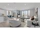 Open-concept living room and kitchen with modern furnishings and plenty of natural light at 6276 Desert Orchid Way, Las Vegas, NV 89141