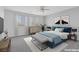 Cozy bedroom features a ceiling fan, natural light and soft color palette, with an ensuite at 6276 Desert Orchid Way, Las Vegas, NV 89141