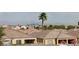 A sprawling neighborhood showcases tile roofs, palm trees, and a stunning city skyline in the distance at 6276 Desert Orchid Way, Las Vegas, NV 89141