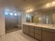 Modern bathroom featuring a glass shower, double vanity, and sleek countertops at 629 Soaring Wings Ave, Las Vegas, NV 89183
