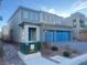 Two-story home featuring a blue two-car garage, a covered entry, and well-maintained landscaping at 629 Soaring Wings Ave, Las Vegas, NV 89183