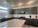 Modern kitchen with gray cabinets, quartz countertops, stainless steel appliances, and island at 629 Soaring Wings Ave, Las Vegas, NV 89183