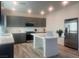 Spacious kitchen featuring stainless steel appliances, gray cabinets, and a center island at 629 Soaring Wings Ave, Las Vegas, NV 89183