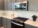 Updated kitchen with stainless steel microwave above gas range, and white countertops at 629 Soaring Wings Ave, Las Vegas, NV 89183