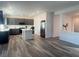 Open-concept kitchen with stainless steel appliances, a center island, and hardwood floors at 629 Soaring Wings Ave, Las Vegas, NV 89183