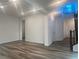 Spacious living area with hardwood floors, white walls, and modern lighting fixtures at 629 Soaring Wings Ave, Las Vegas, NV 89183