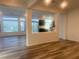Bright, open-concept living room with wood floors, plenty of natural light, and view into the modern kitchen at 629 Soaring Wings Ave, Las Vegas, NV 89183