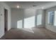 Bright living room with large windows offering plenty of natural light and neutral carpet at 629 Soaring Wings Ave, Las Vegas, NV 89183