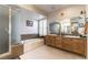 Clean bathroom featuring a double vanity, large soaking tub, and frosted glass shower stall at 6509 Vicuna Dr, Las Vegas, NV 89146