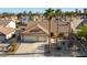 Stunning aerial view of a home featuring mature landscaping, a three-car garage, and a tile roof at 6509 Vicuna Dr, Las Vegas, NV 89146