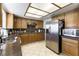 Modern kitchen with stainless appliances, granite countertops, tile flooring, and natural light at 6509 Vicuna Dr, Las Vegas, NV 89146