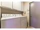 Bright laundry room with tile floors, washer, dryer, and upper cabinets for convenient storage at 6509 Vicuna Dr, Las Vegas, NV 89146