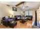 Inviting living room featuring hardwood floors, ceiling fan, vaulted ceiling, and comfortable leather furnishings at 6509 Vicuna Dr, Las Vegas, NV 89146