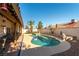 Backyard pool featuring palm trees, patio, surrounding privacy walls, and relaxing space for entertaining at 6509 Vicuna Dr, Las Vegas, NV 89146