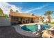 Backyard pool featuring palm trees, patio, surrounding privacy walls, and relaxing space for entertaining at 6509 Vicuna Dr, Las Vegas, NV 89146