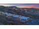 Elevated view of luxury homes, a sparkling pool, and a well-manicured neighborhood nestled on a mountainside at 658 Falcon Summit Ct, Henderson, NV 89012
