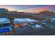 Modern home with an outdoor patio, a cozy fire pit, and a sparkling swimming pool offering stunning mountain views at 658 Falcon Summit Ct, Henderson, NV 89012