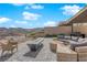 Beautiful outdoor space with modern seating, a fire pit, and scenic mountain views at 658 Falcon Summit Ct, Henderson, NV 89012