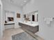 Double sink bathroom vanity with a tiled floor, a large mirror, and good lighting at 658 Falcon Summit Ct, Henderson, NV 89012