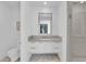 Contemporary bathroom featuring a floating vanity, modern fixtures, a spacious glass shower, and unique pebble flooring for an upscale feel at 658 Falcon Summit Ct, Henderson, NV 89012