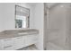 Modern bathroom showcasing a sleek vanity, large mirror, glass-enclosed shower, and stylish pebble flooring for a spa-like experience at 658 Falcon Summit Ct, Henderson, NV 89012
