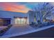 Modern home exterior featuring a multi car garage, xeriscaping, and smooth stucco at 658 Falcon Summit Ct, Henderson, NV 89012