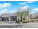 Modern home featuring desert landscaping, a driveway, and a multi-car garage under a bright blue sky at 658 Falcon Summit Ct, Henderson, NV 89012