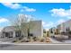 Modern house with well-maintained desert landscaping, a private walkway, and unique architectural design at 658 Falcon Summit Ct, Henderson, NV 89012